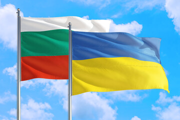 Ukraine and Bulgaria national flag waving in the windy deep blue sky. Diplomacy and international relations concept.