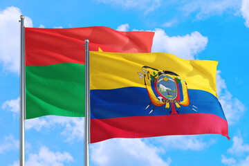 Ecuador and Burkina Faso national flag waving in the windy deep blue sky. Diplomacy and international relations concept.