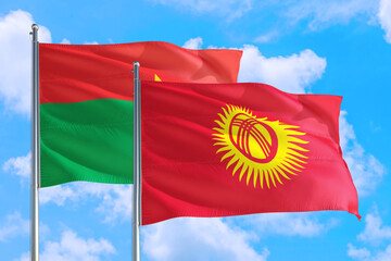 Kyrgyzstan and Burkina Faso national flag waving in the windy deep blue sky. Diplomacy and international relations concept.