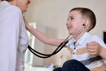 The child is at the pediatrician appointment. He listening to a stethoscope