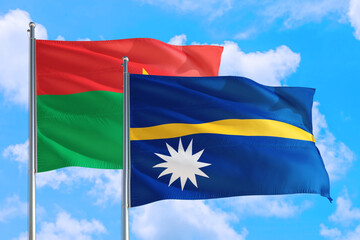 Nauru and Burkina Faso national flag waving in the windy deep blue sky. Diplomacy and international relations concept.