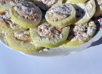 
zucchini with minced meat lie on a white background