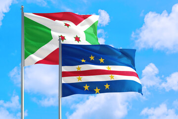 Cape Verde and Burundi national flag waving in the windy deep blue sky. Diplomacy and international relations concept.
