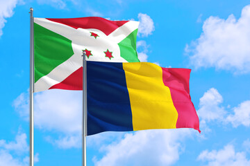 Chad and Burundi national flag waving in the windy deep blue sky. Diplomacy and international relations concept.