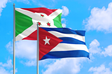 Cuba and Burundi national flag waving in the windy deep blue sky. Diplomacy and international relations concept.