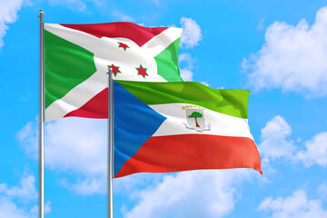 Equatorial Guinea and Burundi national flag waving in the windy deep blue sky. Diplomacy and international relations concept.