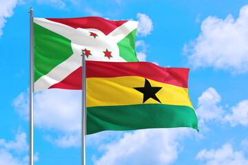 Ghana and Burundi national flag waving in the windy deep blue sky. Diplomacy and international relations concept.