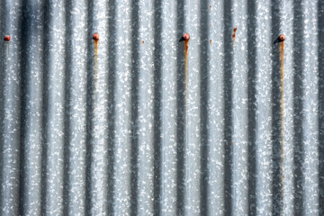 rusty metal background. Minimalist Detail Of Weathered Corrugated Zinc Roof Sheet With Soft Sunlight, Backgrounds, Textures. Stock Photograph.