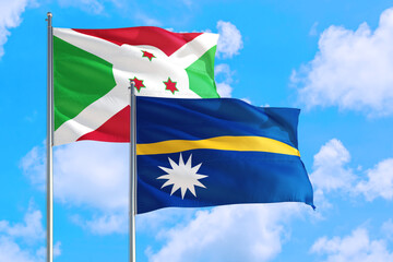 Nauru and Burundi national flag waving in the windy deep blue sky. Diplomacy and international relations concept.