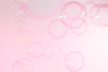 Beautiful shiny transparent soap bubbles float on pink background. Abstract, Celebration, Natual fresh summer, Chrimas holiday background.