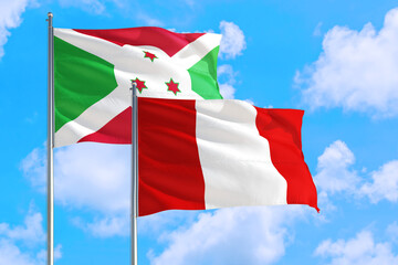 Peru and Burundi national flag waving in the windy deep blue sky. Diplomacy and international relations concept.