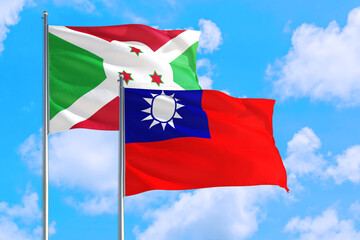 Taiwan and Burundi national flag waving in the windy deep blue sky. Diplomacy and international relations concept.