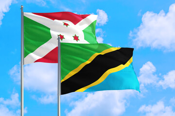Tanzania and Burundi national flag waving in the windy deep blue sky. Diplomacy and international relations concept.