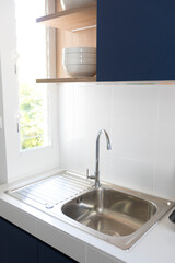Water flows from a faucet into the sink of the kitchen.