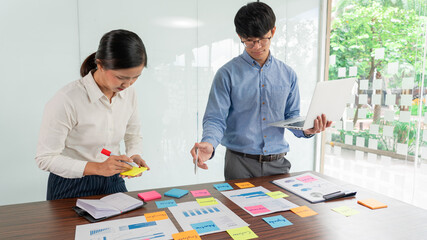 Businessman stick colorful notes to brainstorming on the table working on new project to share idea to thinking how to planning new case