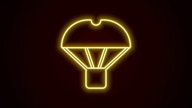 Glowing neon line Box flying on parachute icon isolated on black background. Parcel with parachute for shipping. Delivery service, air shipping. 4K Video motion graphic animation