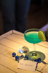 The cocktail drink is in a clear glass for the party.