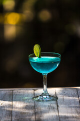 The cocktail drink is in a clear glass for the party.