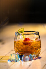 The cocktail drink is in a clear glass for the party.