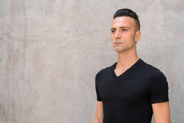 Portrait of handsome young Italian man with undercut wearing black t-shirt