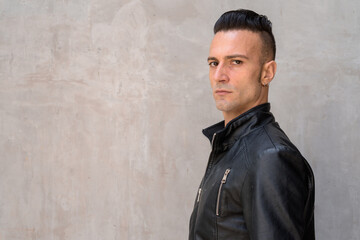 Handsome young Italian man with undercut wearing black leather jacket