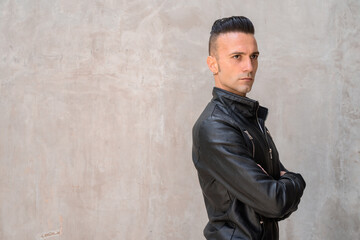 Naklejka premium Handsome young Italian man with undercut wearing black leather jacket