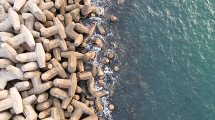 Aerial drone view of a breakwater. breakwater in the sea, a collection of concrete breakers
