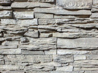 Abstract background wall covered with stone. Stone wall background brown. Decorative stone on the wall. Selective focus
