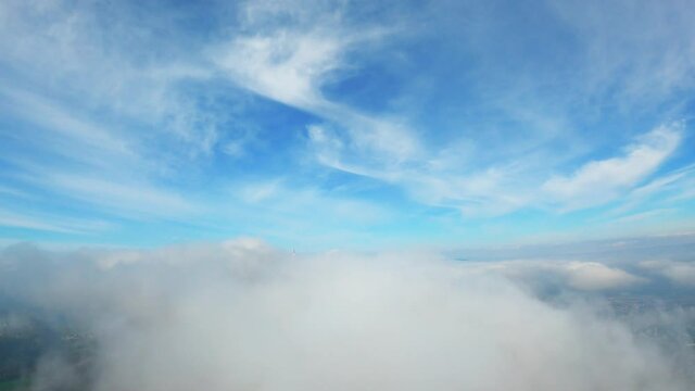 drone flight over and through the clouds near Z&uuml;rich revealing an antenna tower and a view point