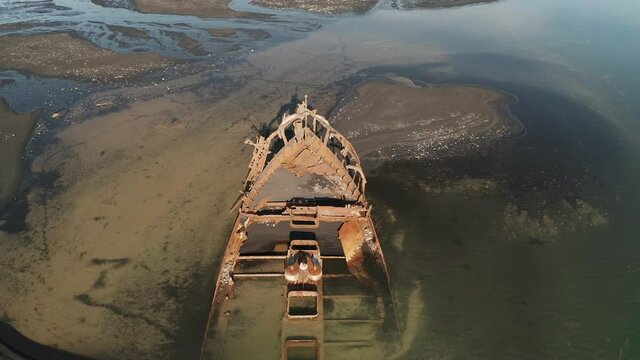 Shipwreck In Breidamerkursandur, South Iceland - Abandoned And Rusted FV Clyne Castle Trawler Ship - ascending drone shot