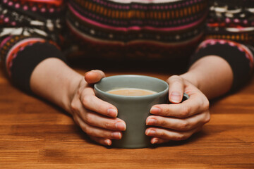 Fototapeta na wymiar Young woman drinking hot cocoa or coffee. Autumn or winter moody weekend, New Year and Christmas background. Lazy day, quarantine, stay home, cosy scene, hygge concept.