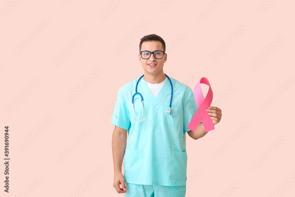 Wall mural Doctor with pink ribbon on color background. Breast cancer awareness concept