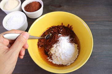 Hand Mixing Ingredient in a Bowl for Baking Chocolate Cake