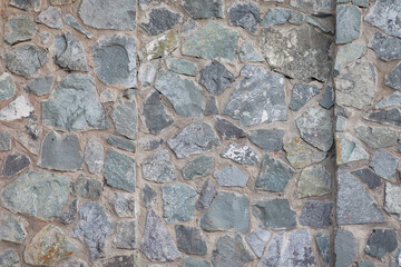 A photo of a stone wall with granite and crushed stone. Stone texture for Photoshop and montage