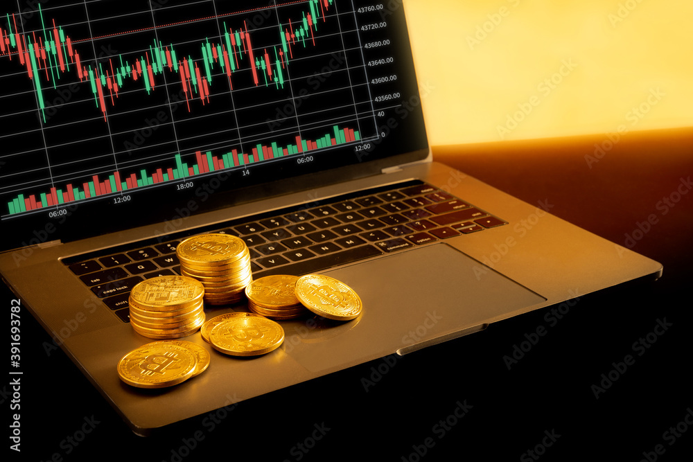 Sticker Bitcoins on a laptop on a golden background