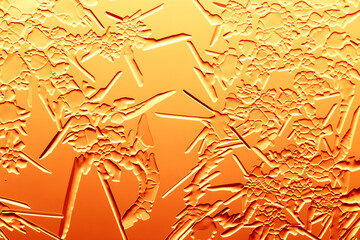 Gold patterns from frost on glass as a background.