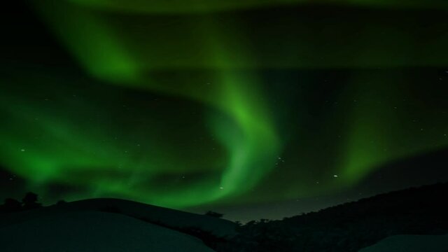 aurora against the foreground of the icy mountain plains.