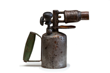 Rusty gasoline fueled blowtorch stands right side on a white background