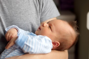 Midsection of man holding newborn baby