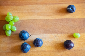 Summer fruits lie on a wooden surface.