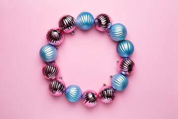Shiny Christmas blue and pink balls circle for decoration on pink background , new year ball