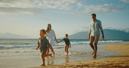 Happy young family playing at the beach on vacation - Powered by Adobe