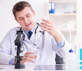 Male doctor looking at lab results in hospital