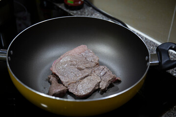 Close up shot of steak on frying pan