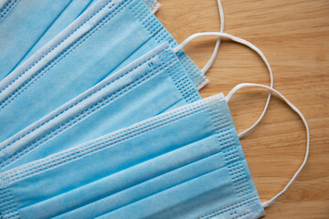antibacterial medical mask of blue color on a wooden background virus epidemic coronavirus...