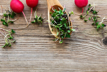 Heap of radish micro greens on old wooden  background. Healthy eating concept.