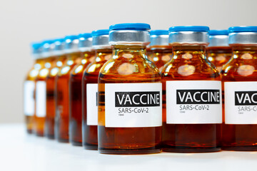 Sars-cov-2 vaccine vial bottles on white table