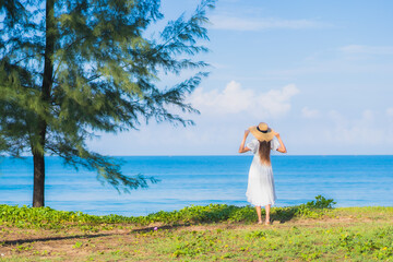 Portrait beautiful young asian woman relax smile around beach sea ocean with blue sky white cloud