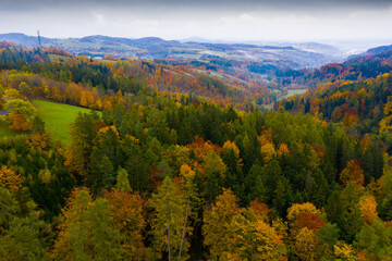 Scenic aerial view of autumn hilly landscape with colored trees