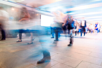 Crowd of People as Pedestrians in Metro, blurred Picture as Background